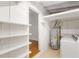 Unfinished basement featuring a laundry area with a washer and dryer, along with some storage shelves at 2037 Lenox Ne Rd, Atlanta, GA 30324