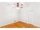Bedroom with hardwood floors, ceiling fan, built-in bookshelves and closet with white trim at 2037 Lenox Ne Rd, Atlanta, GA 30324
