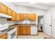 Well-lit kitchen featuring matching appliances, wooden cabinets, stone-look countertops, and tile flooring at 2037 Lenox Ne Rd, Atlanta, GA 30324