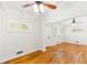 Bright living room featuring hardwood floors, ceiling fans, and freshly painted walls with large window at 2037 Lenox Ne Rd, Atlanta, GA 30324