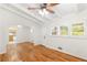 Bright living room featuring hardwood floors, a ceiling fan, and freshly painted walls with view into kitchen at 2037 Lenox Ne Rd, Atlanta, GA 30324