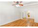 Bright living room featuring hardwood floors, a ceiling fan, and freshly painted walls with view into kitchen at 2037 Lenox Ne Rd, Atlanta, GA 30324