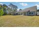 A large grassy backyard offering ample space, accompanied by a covered patio and outdoor seating area at 2526 Knob Creek Dr, Snellville, GA 30078