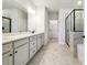 Bright bathroom featuring a double sink vanity with stone countertops and a glass-enclosed shower at 2526 Knob Creek Dr, Snellville, GA 30078