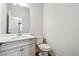 Bathroom featuring a white vanity with cultured marble countertop, modern faucet, toilet, and tile floors at 2526 Knob Creek Dr, Snellville, GA 30078