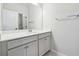 Bathroom vanity with neutral cabinets, a white countertop, and a large mirror at 2526 Knob Creek Dr, Snellville, GA 30078