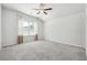 Bedroom with ceiling fan, carpeted floors, natural light from windows, and neutral walls at 2526 Knob Creek Dr, Snellville, GA 30078