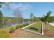 Bocce ball court set by a tranquil lake, offering a picturesque recreational spot within the community at 2526 Knob Creek Dr, Snellville, GA 30078