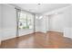Bright dining room featuring wood floors, wainscoting, and large window with natural light at 2526 Knob Creek Dr, Snellville, GA 30078