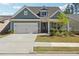 Charming home featuring a two-car garage, manicured lawn, and inviting front porch at 2526 Knob Creek Dr, Snellville, GA 30078