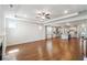Open-concept layout with hardwood floors, fireplace, and a view into the modern kitchen at 2526 Knob Creek Dr, Snellville, GA 30078
