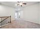 Living room with carpeted floors, ceiling fan, stairs with decorative railing, and recessed lighting at 2526 Knob Creek Dr, Snellville, GA 30078