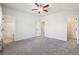 Large primary bedroom with ceiling fan, plush carpet, ensuite bathroom, and walk-in closet at 2526 Knob Creek Dr, Snellville, GA 30078