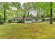 Backyard featuring a covered parking area and lush landscaping, creating a tranquil outdoor space at 2963 Williams Pl, Snellville, GA 30078