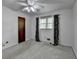 Bedroom featuring neutral carpeting, ceiling fan, and dark decorative window treatments at 2963 Williams Pl, Snellville, GA 30078