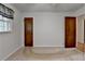 Bedroom featuring neutral carpet, window with decorative curtains, and two wood doors at 2963 Williams Pl, Snellville, GA 30078