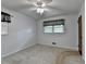 Bedroom featuring neutral carpet, window with decorative curtains and a closed door at 2963 Williams Pl, Snellville, GA 30078