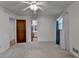 Bedroom featuring neutral carpet, an adjacent bathroom, and a window with decorative curtains at 2963 Williams Pl, Snellville, GA 30078