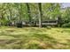 Charming one-story home with black shutters surrounded by mature trees and a spacious front lawn at 2963 Williams Pl, Snellville, GA 30078