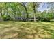 Charming one-story home with black shutters surrounded by mature trees and a spacious front lawn at 2963 Williams Pl, Snellville, GA 30078