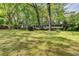 Charming one-story home with black shutters surrounded by mature trees and a spacious front lawn at 2963 Williams Pl, Snellville, GA 30078