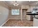 Cozy eat-in kitchen area with a bright window and brick-look floors at 2963 Williams Pl, Snellville, GA 30078