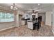 Kitchen area featuring white cabinets, black countertops, and an island with seating for casual dining at 2963 Williams Pl, Snellville, GA 30078