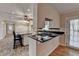 Modern kitchen island with seating, stainless steel appliances, and brick-patterned floors at 2963 Williams Pl, Snellville, GA 30078