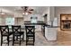 Spacious kitchen featuring an island, sleek countertops, stainless steel appliances, and brick fireplace at 2963 Williams Pl, Snellville, GA 30078