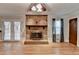 Living room featuring a brick fireplace, wood floors, french doors and natural light at 2963 Williams Pl, Snellville, GA 30078