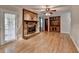 Living room with brick fireplace, wood floors, and ceiling fan at 2963 Williams Pl, Snellville, GA 30078