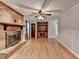 Spacious living room with wood floors, brick fireplace, ceiling fan and built-in cabinets at 2963 Williams Pl, Snellville, GA 30078