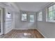 Bright sunroom with wood-look flooring, white trim, and multiple windows that let in plenty of natural light at 2963 Williams Pl, Snellville, GA 30078