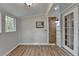 Light-filled sunroom showcasing wood-look flooring and a small window AC unit at 2963 Williams Pl, Snellville, GA 30078