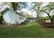 Spacious backyard with swing set, picnic table, and a charming cottage with pale blue siding at 3078 Semmes St, East Point, GA 30344