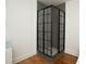 Modern shower with grid pane enclosure and gray tiled walls at 3078 Semmes St, East Point, GA 30344