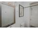 Modern bathroom featuring a tiled shower, toilet, and a large mirror in a neutral color palette at 3078 Semmes St, East Point, GA 30344