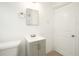 Bathroom with gray vanity, square sink, and brushed silver fixtures at 3078 Semmes St, East Point, GA 30344