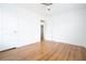 Bright bedroom featuring hardwood floors, white walls, and ceiling fan at 3078 Semmes St, East Point, GA 30344