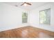 Sun-filled bedroom featuring hardwood floors, white walls, and two windows at 3078 Semmes St, East Point, GA 30344