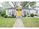 Charming home featuring a cheerful yellow door, window boxes, and a well-manicured front yard at 3078 Semmes St, East Point, GA 30344