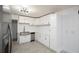 Modern kitchen featuring white cabinets, stainless steel appliances, and a farmhouse style sink at 3078 Semmes St, East Point, GA 30344