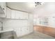 Bright kitchen with white cabinets, quartz counters, stainless sink, and view to the living area at 3078 Semmes St, East Point, GA 30344
