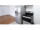 Well lit kitchen featuring stainless appliances, a range, and white cabinets at 3078 Semmes St, East Point, GA 30344