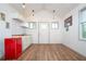 Cozy kitchenette with white cabinets, a wood countertop, a retro mini-fridge, and wood flooring at 3078 Semmes St, East Point, GA 30344