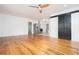 Open living room with hardwood floors, ceiling fan, barn door and modern stainless steel kitchen at 3078 Semmes St, East Point, GA 30344