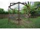 Backyard swing set with built-in bench swings surrounding a fire pit, next to a picnic table at 3078 Semmes St, East Point, GA 30344