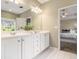 Bright bathroom featuring double vanity with white cabinets and a view into the adjacent bedroom at 3499 Henderson Reserve, Atlanta, GA 30341