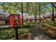 Community park with Little Free Library, bench, and landscaped common area between townhomes at 3499 Henderson Reserve, Atlanta, GA 30341