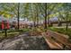 Charming community park with walking path, bench, and 'Little Free Library' among landscaped townhomes at 3499 Henderson Reserve, Atlanta, GA 30341